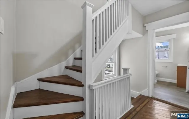 a view of entryway bedroom and gallery with wooden floor