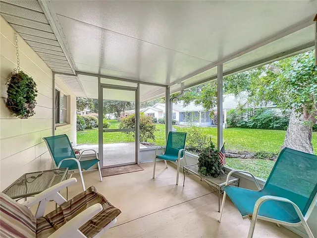 a building outdoor space with patio furniture and garden