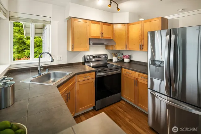a kitchen with a sink stove and refrigerator