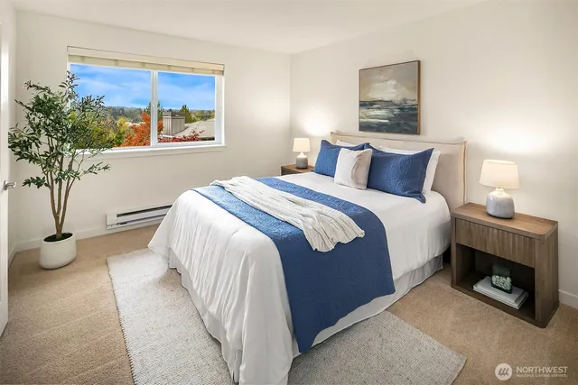 a bedroom with a bed and a potted plant