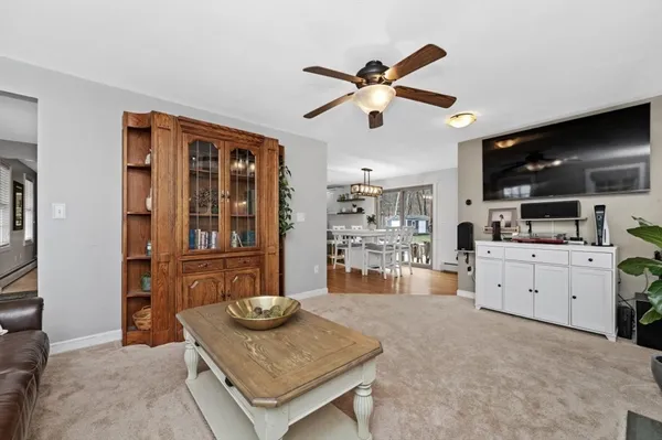 a living room with furniture and kitchen view