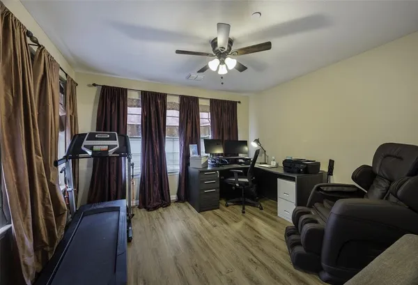 a view of a livingroom with furniture hardwood floor and a ceiling fan