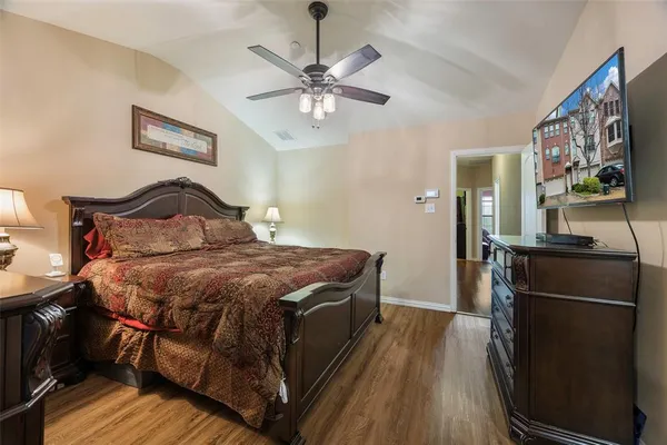 a bedroom with a bed and wooden floor