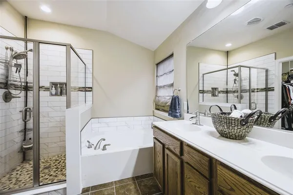 a bathroom with a tub sink and mirror