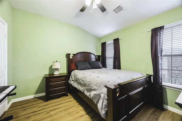 a bed sitting in a bedroom next to a window