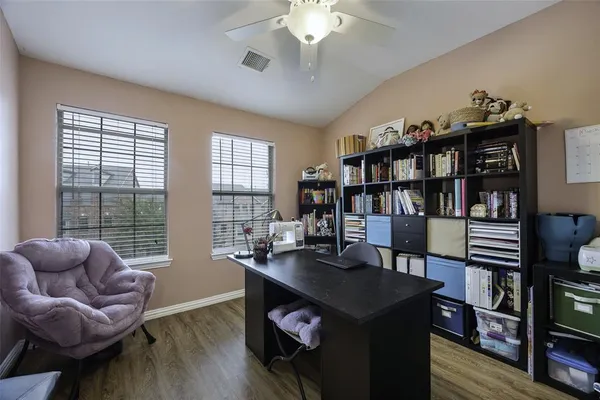 a living room with furniture a bookshelf and a book shelf