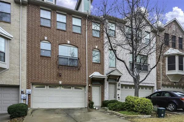 a front view of a residential houses with yard
