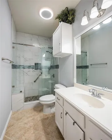 a bathroom with a sink a toilet and a shower