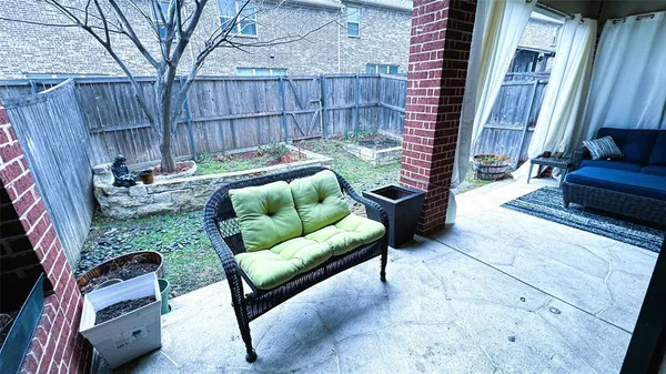 a view of a backyard with furniture and a fire pit