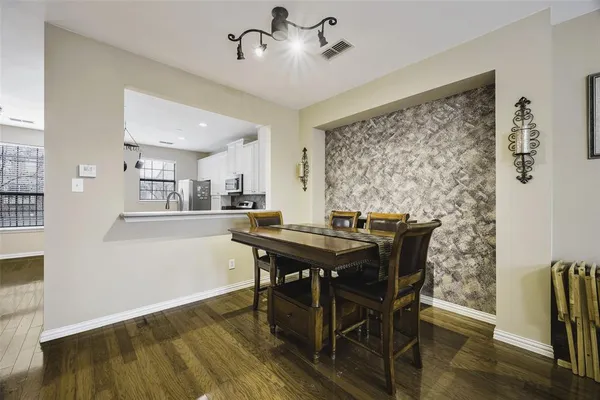 a view of a dining room with furniture and wooden floor