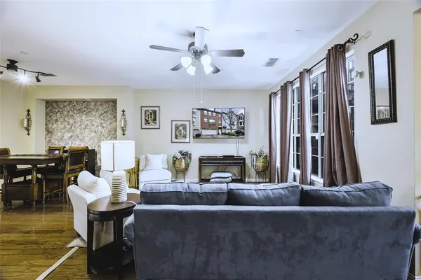 a living room with furniture and wooden floor
