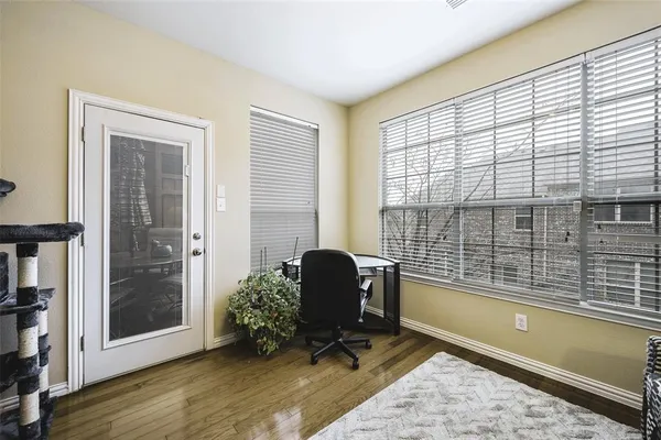 a view of a workspace with furniture and a window