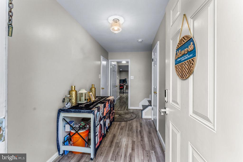11409 Hermosa Drive Laurel, MD 20708 - Photo 3 of 28 a view of a hallway with wooden floor and a workspace