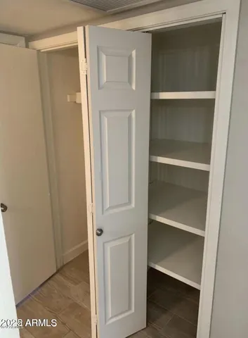 a view of walk in closet with empty racks