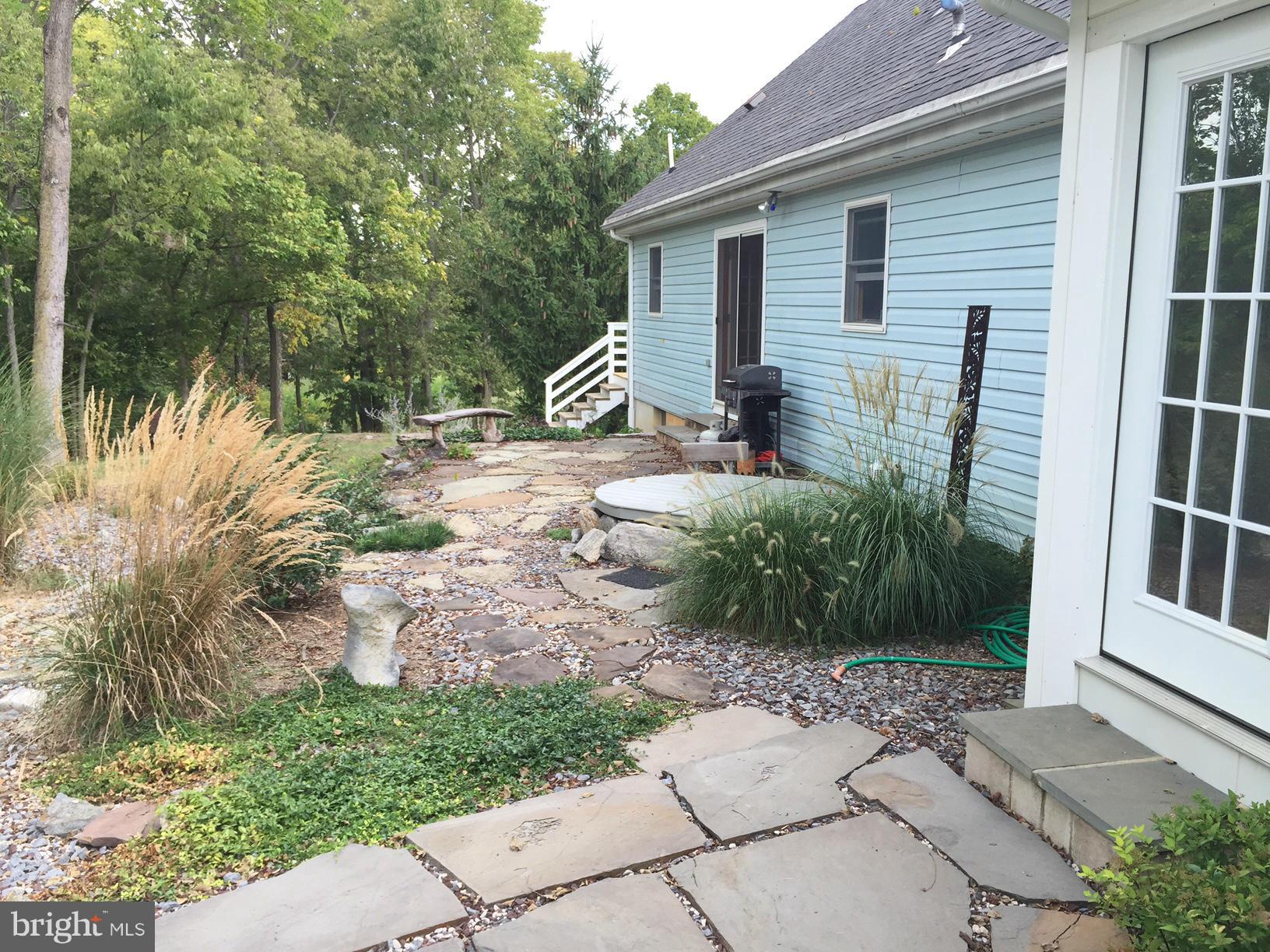 539 Turner Road Shepherdstown, WV 25443 - Photo 5 of 29 a front view of a house with a yard and potted plants