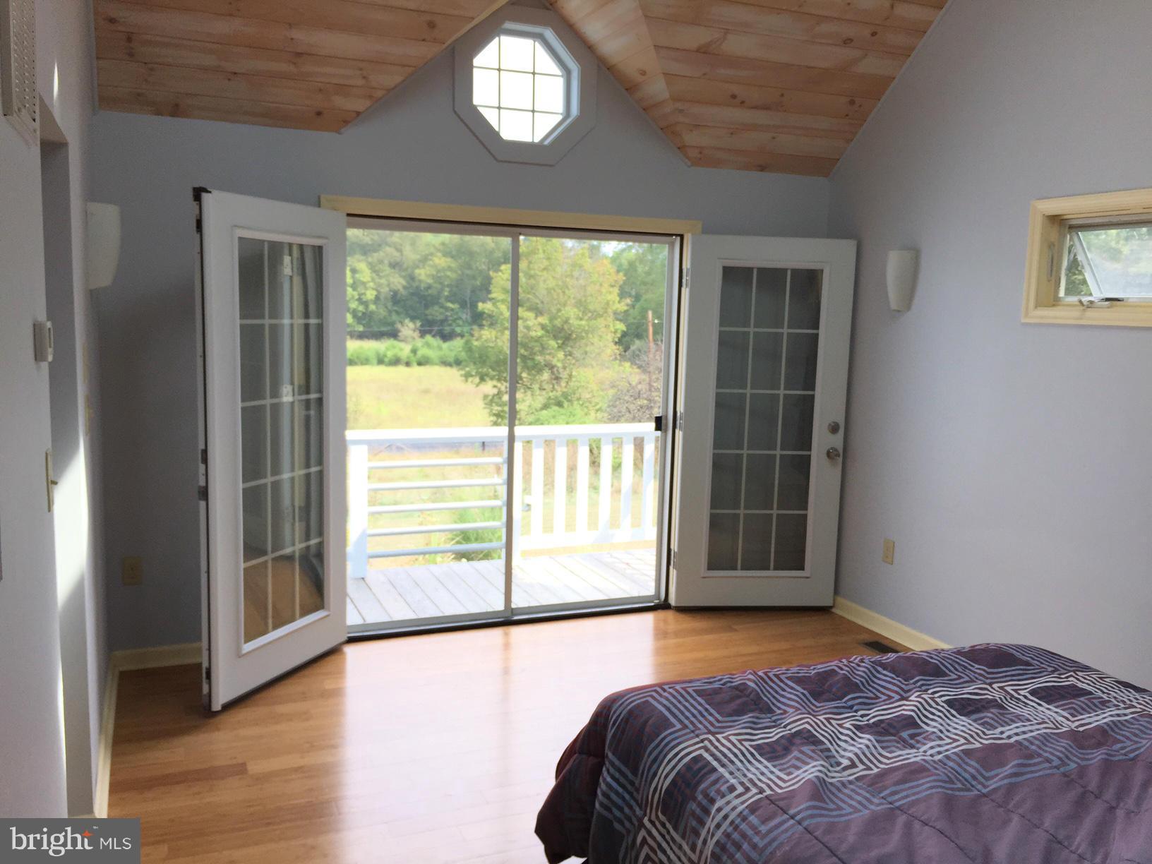 539 Turner Road Shepherdstown, WV 25443 - Photo 8 of 29 a view of a bedroom with wooden floor and a window