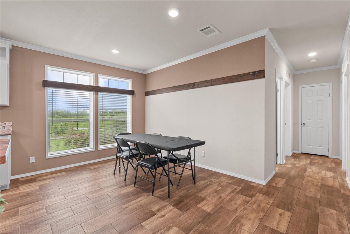 8710 Fm 646 Road South Santa Fe, TX 77510 - Photo 7 of 32 Spacious dining room featuring large windows that fill the space with natural light and offer a beautiful view of the backyard