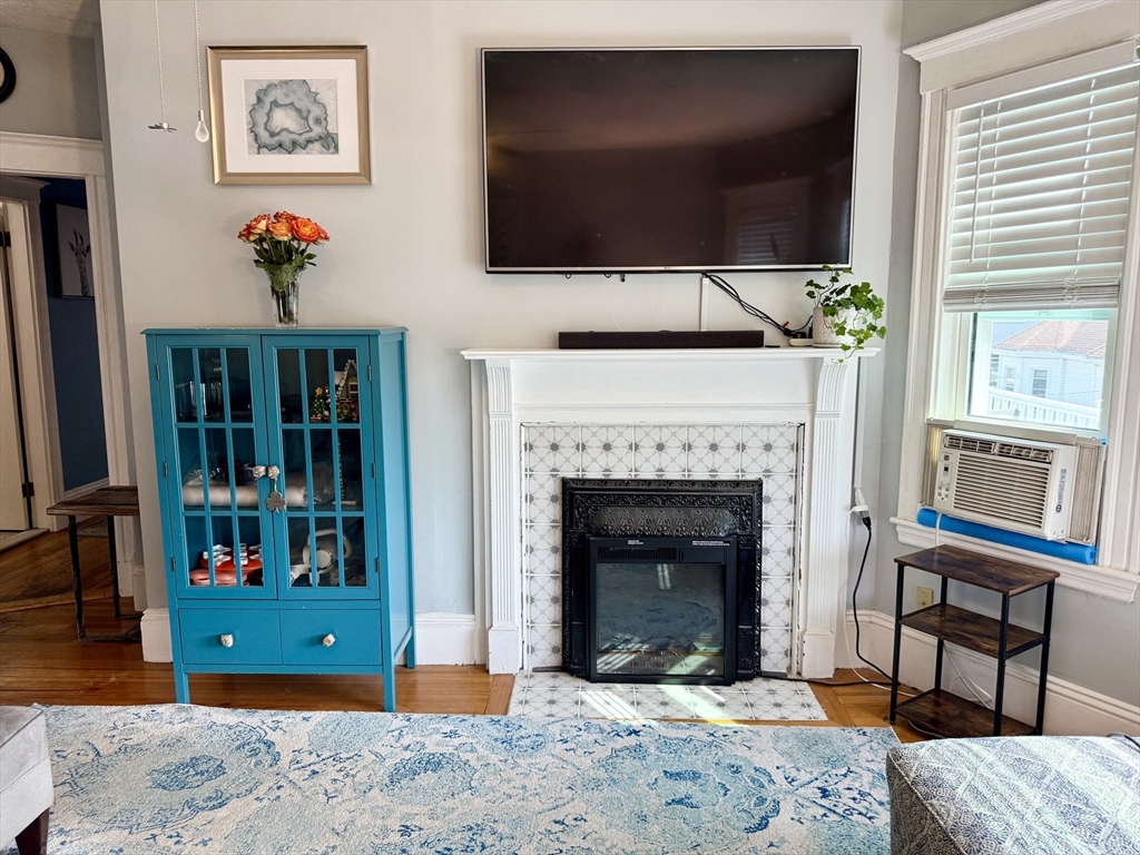 26 Forrest Street, Unit 3 Winthrop, MA 02152 - Photo 2 of 21 a living room with a fireplace furniture and a flat screen tv
