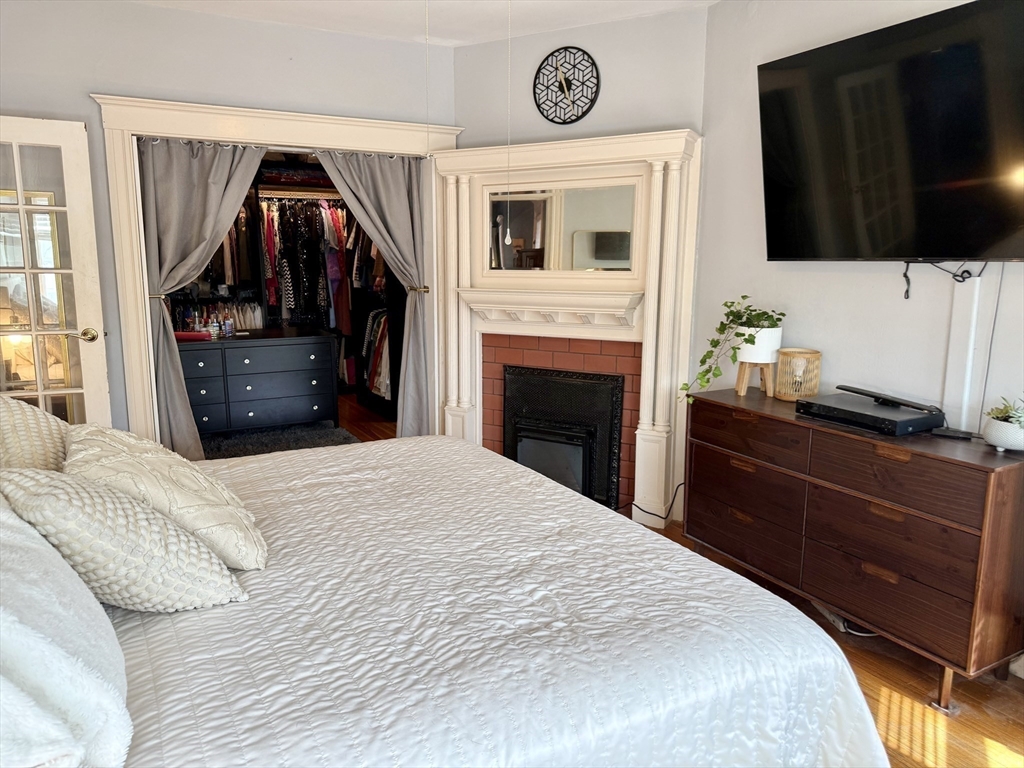 26 Forrest Street, Unit 3 Winthrop, MA 02152 - Photo 7 of 21 a bedroom with a bed and a flat screen tv