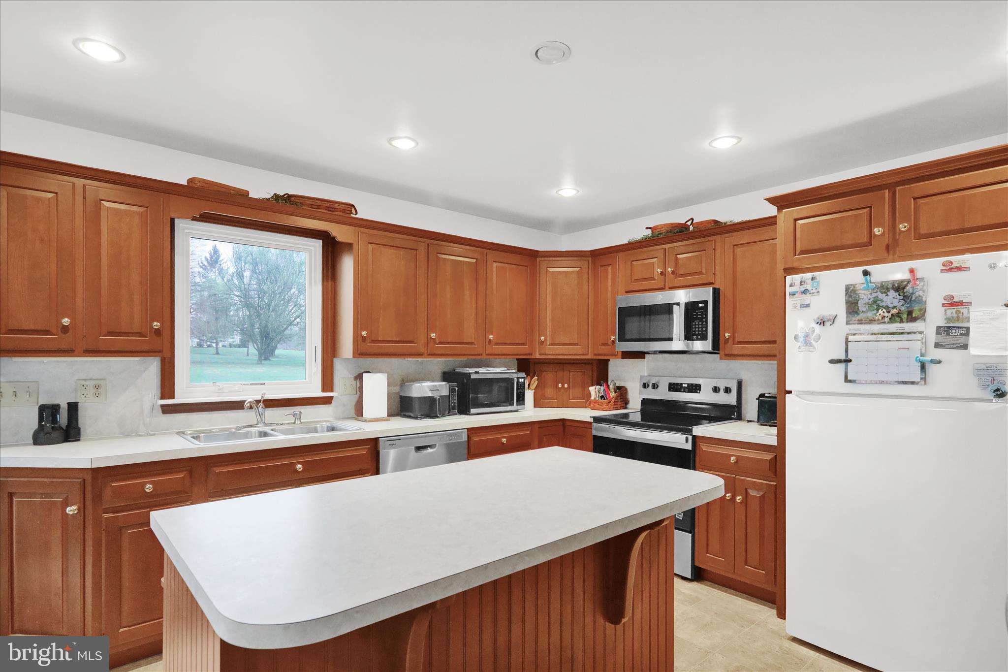 16 Mt Wilson Road Lebanon, PA 17042 - Photo 12 of 30 a kitchen with stainless steel appliances granite countertop a refrigerator a sink dishwasher a stove top oven a dining table and chairs with wooden floor