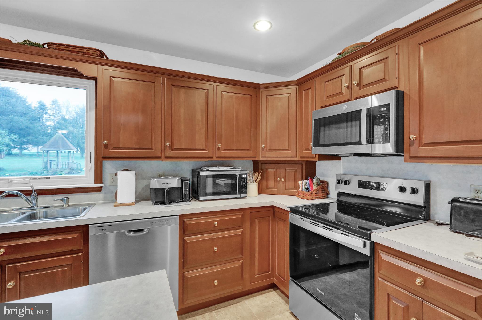 16 Mt Wilson Road Lebanon, PA 17042 - Photo 13 of 30 a kitchen with stainless steel appliances granite countertop a stove a sink dishwasher and a microwave oven with cabinets