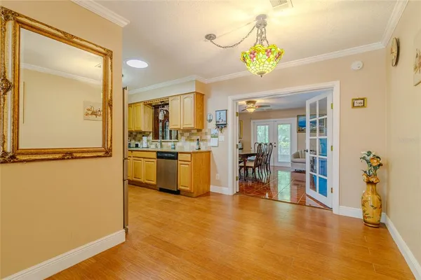 a kitchen with stainless steel appliances granite countertop a sink and cabinets with wooden floor