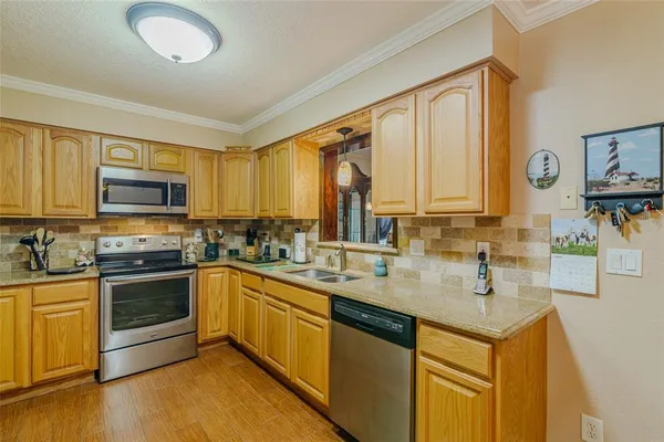 a kitchen with stainless steel appliances a stove sink and microwave