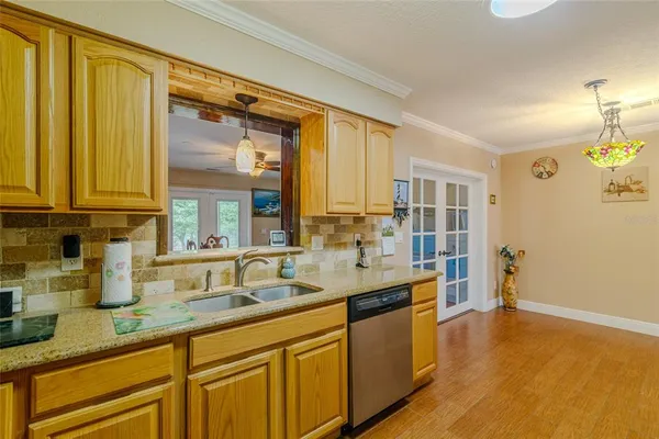 a kitchen with a refrigerator and a chandelier