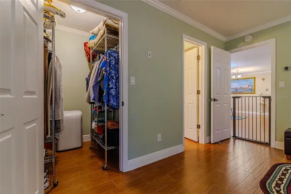 a view of an empty room with wooden floor and windows