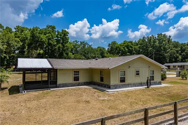 a view of a house with a backyard