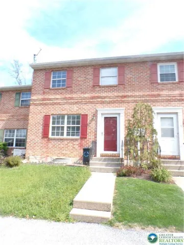 front view of a house with a yard