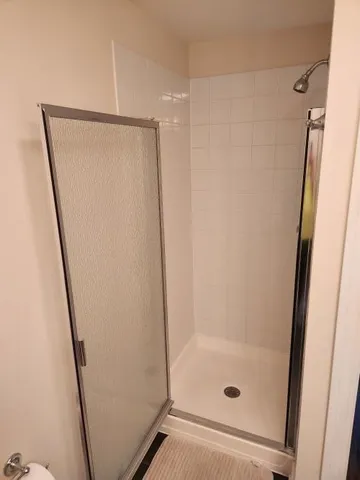 a bathroom with a glass door shower