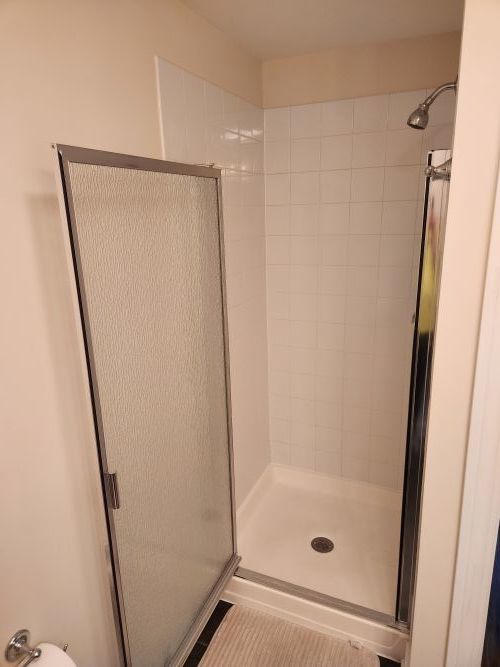 8440 Callie Avenue, Unit 410 Morton Grove, IL 60053 - Photo 12 of 27 a bathroom with a glass door shower