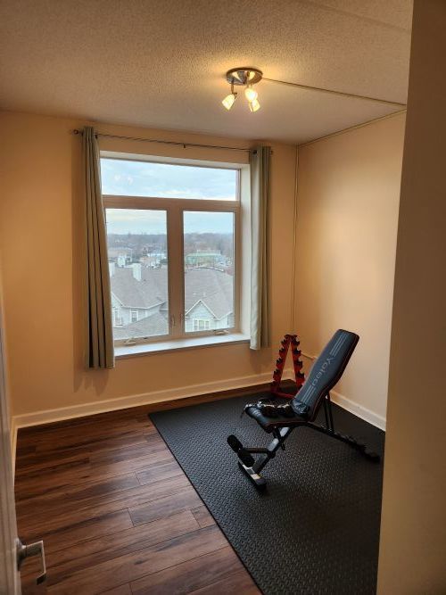 8440 Callie Avenue, Unit 410 Morton Grove, IL 60053 - Photo 15 of 27 a room with gym equipment on the floor and a large window