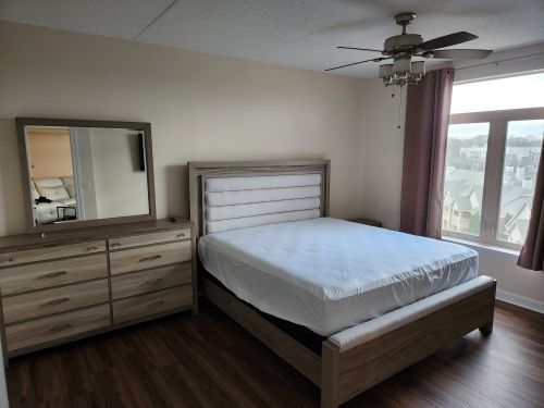 8440 Callie Avenue, Unit 410 Morton Grove, IL 60053 - Photo 16 of 27 a bedroom with a bed and a dresser