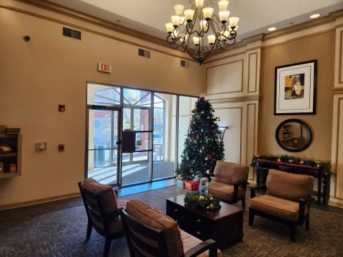 a living room with furniture a chandelier and a window