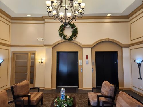 8440 Callie Avenue, Unit 410 Morton Grove, IL 60053 - Photo 3 of 27 a living room with furniture flowerpot and a chandelier