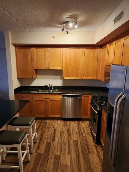 8440 Callie Avenue, Unit 410 Morton Grove, IL 60053 - Photo 9 of 27 a kitchen with a large window appliances and cabinets