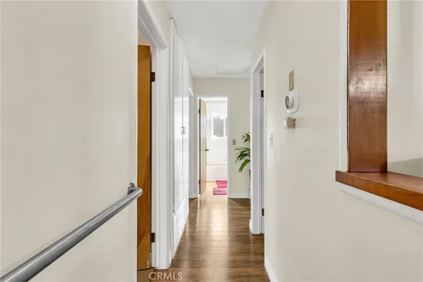 a view of a hallway with wooden floor
