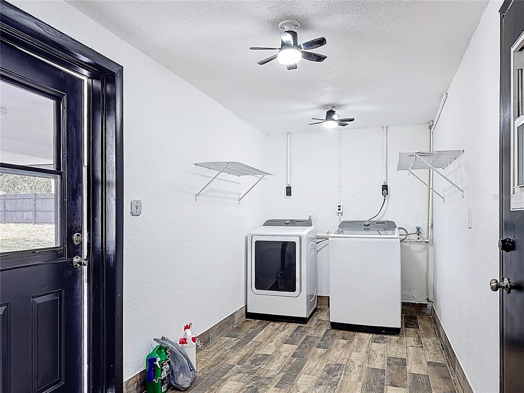 1890 Tyner Road Haines City, FL 33844 - Photo 11 of 48 a view of a kitchen with a stove cabinets and a ceiling fan