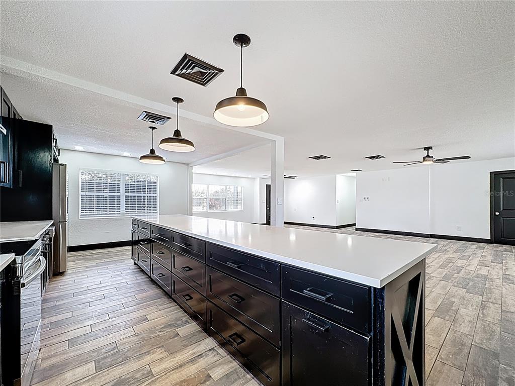 1890 Tyner Road Haines City, FL 33844 - Photo 14 of 48 a living room with wooden floor and flat screen tv