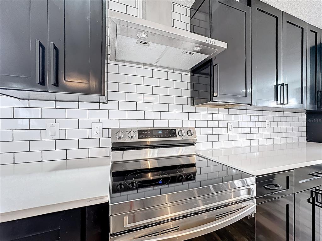 1890 Tyner Road Haines City, FL 33844 - Photo 17 of 48 a kitchen with wooden cabinets and a stove top oven