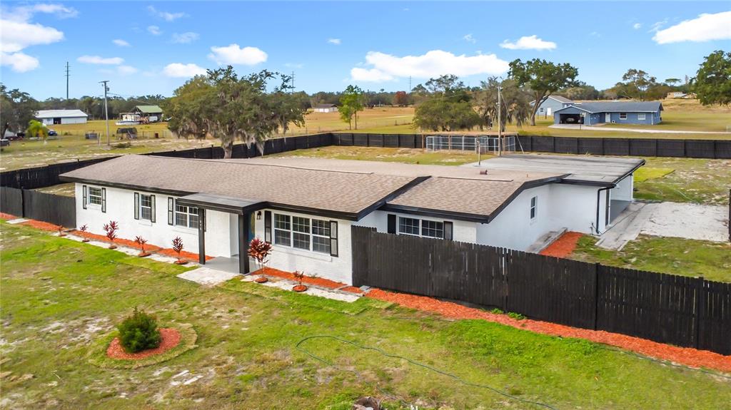 1890 Tyner Road Haines City, FL 33844 - Photo 2 of 48 a front view of a house with a yard table and chairs