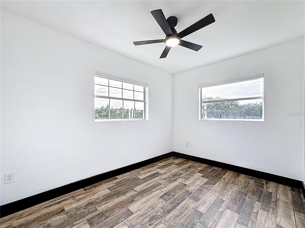 1890 Tyner Road Haines City, FL 33844 - Photo 23 of 48 a view of empty room with wooden floor and fan