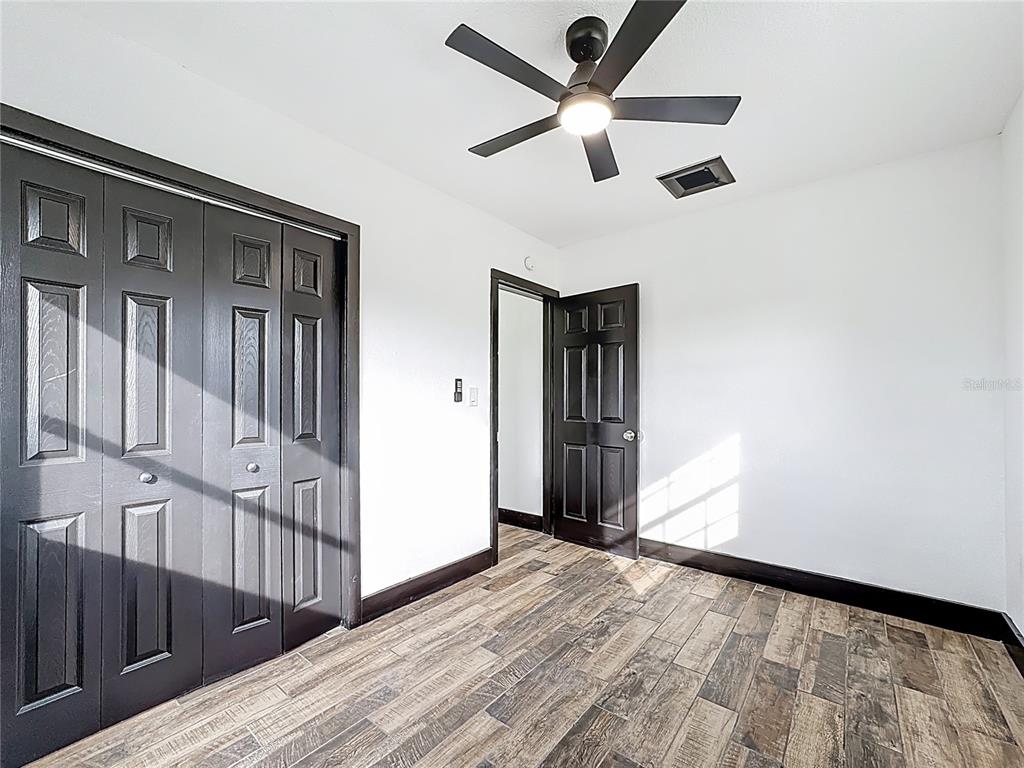 1890 Tyner Road Haines City, FL 33844 - Photo 24 of 48 a view of empty room with wooden floor and fan