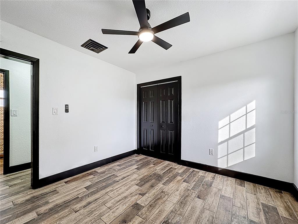 1890 Tyner Road Haines City, FL 33844 - Photo 28 of 48 a view of empty room with wooden floor and fan