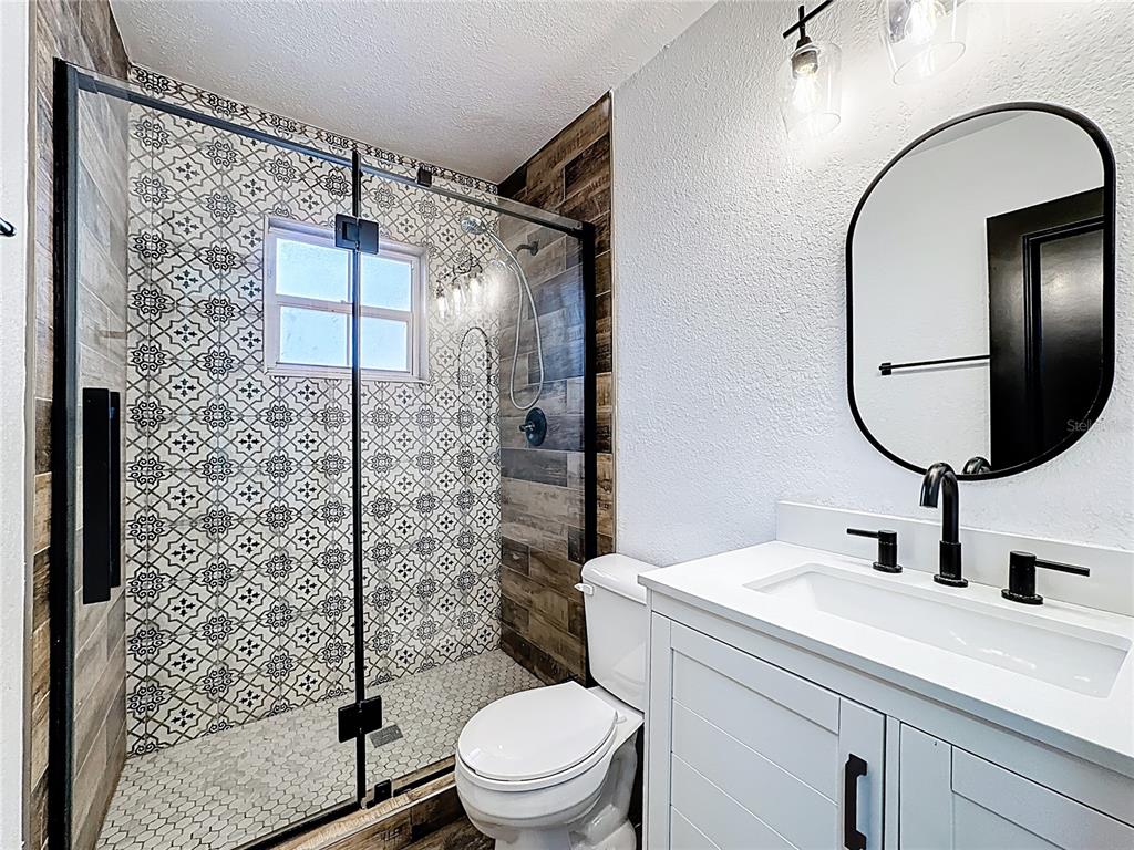 1890 Tyner Road Haines City, FL 33844 - Photo 30 of 48 a bathroom with a sink toilet and shower