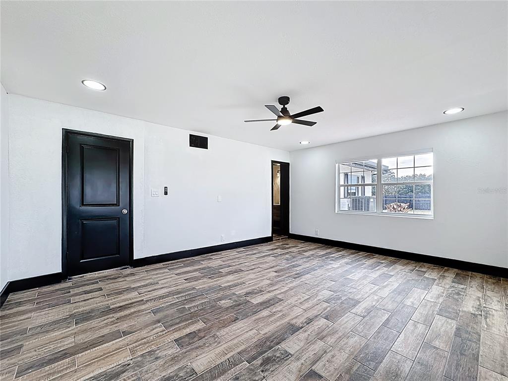 1890 Tyner Road Haines City, FL 33844 - Photo 35 of 48 a view of an empty room with window and wooden floor