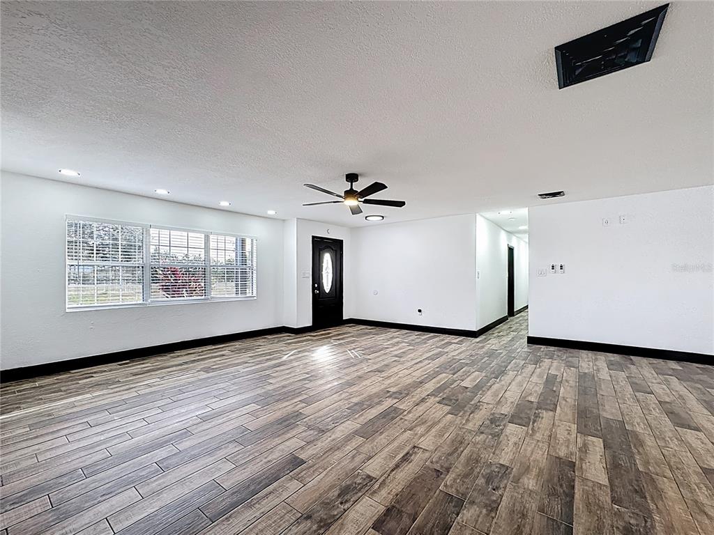 1890 Tyner Road Haines City, FL 33844 - Photo 39 of 48 an empty room with wooden floor and windows