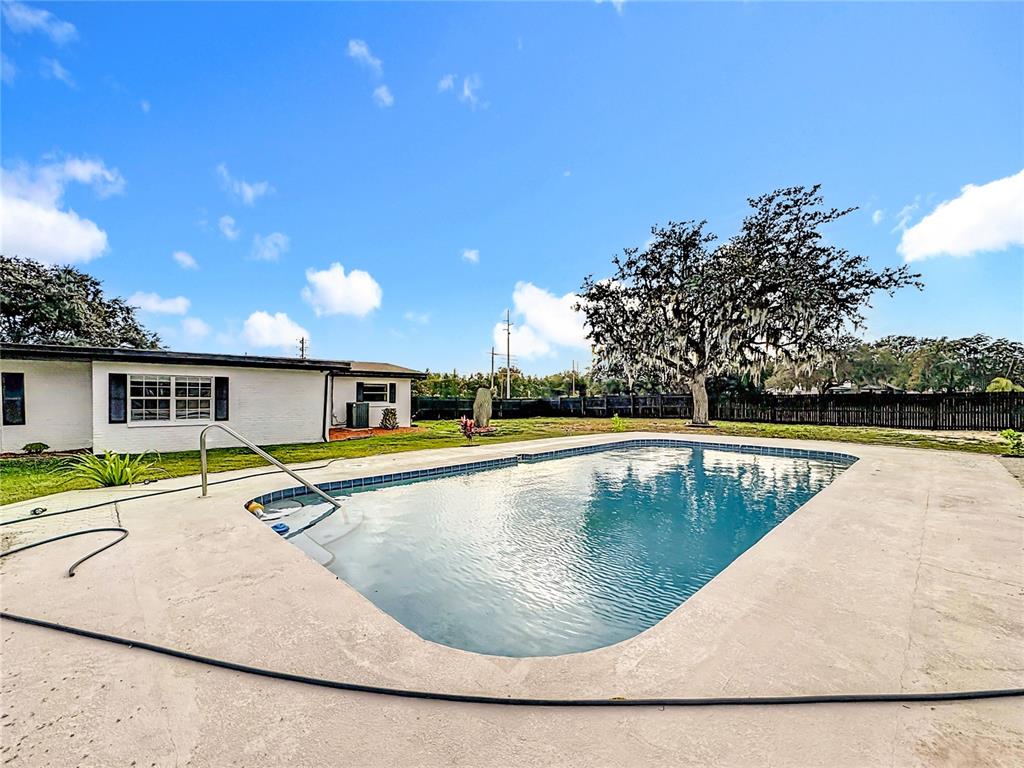 1890 Tyner Road Haines City, FL 33844 - Photo 43 of 48 a view of a swimming pool with a chair and tables